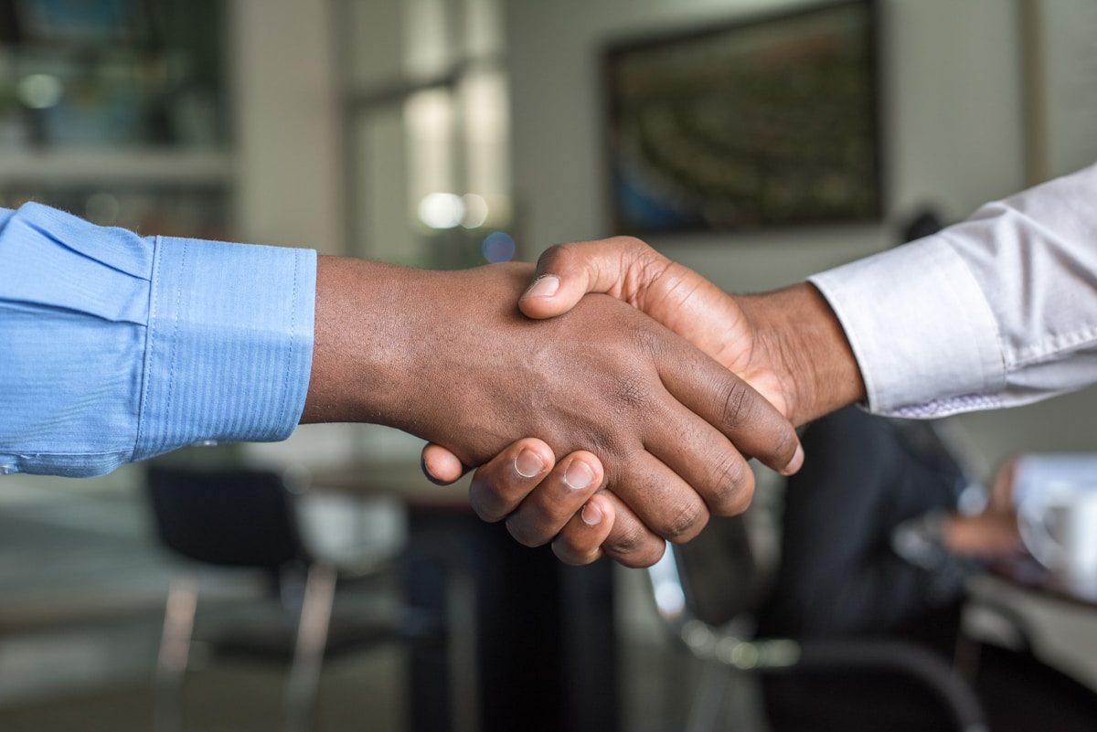 Successful professional handshake after a placement conversation